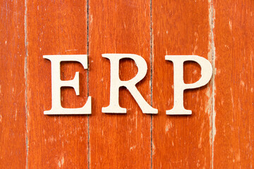 Alphabet letter in word ERP (abbreviation of  Enterprise Resource Planning) on old red color wood plate background