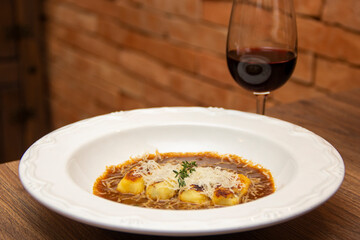 Gnocchi stuffed with ossobuco, ossobuco broth and grana padano cheese