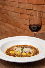 Gnocchi stuffed with ossobuco, ossobuco broth and grana padano cheese