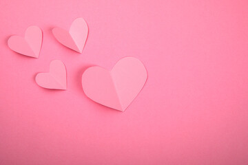 Fototapeta na wymiar Pink hearts, symbolizes a girl or a woman. Falling in love and relationships concept