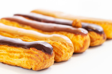French eclair pastry on white background. Art concept.