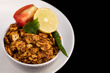 Special And Unique Healthy Indian Snacks Chatpata Namkeen Masala Chana Jor Zor Garam With Aromatic Flavor. Served With Lemon Tomato And Green Chilli. Black Background With Space For Custom Text