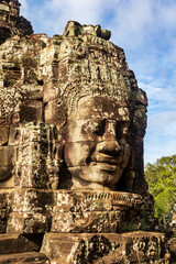 Fototapeta na wymiar Face tower in the Bayon temple in Angkor. Cambodia. Vertical view.
