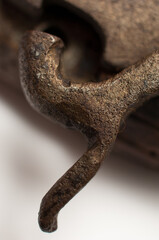 Close up detail of a silver flintlock mechanism with an engraved pattern on an old wooden pistol