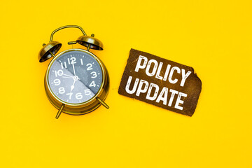 Policies Update on brown card with alarm clock