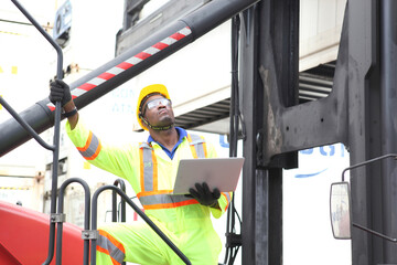 Close up of An African American handsome black engineer he is working in container box yard area