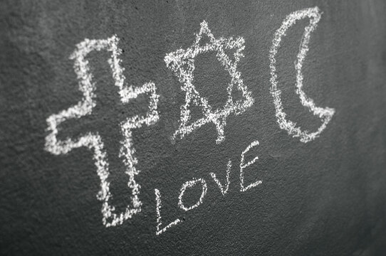 Star of David, Cross and Islamic Crescent on a blackboard
