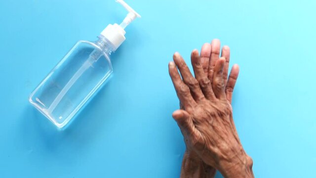 Close Up Of Senior Women Hand Using Sanitizer Gel For Preventing Virus 