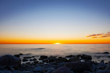 Fototapeta na wymiar Vibrant sunset over calm ocean, Sweden