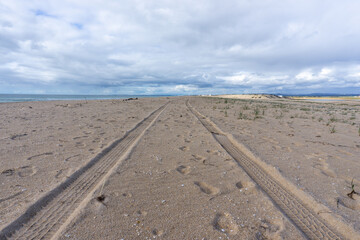 4x4 tire tracks on a sandy beach