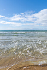 Fototapeta na wymiar clear tropical ocean water with waves on a golden sand beach
