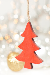 Silver and gold Christmas background with red wooden carved Christmas tree