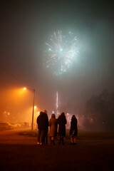 Obraz na płótnie Canvas People celebrating new year with fireworks in the city.