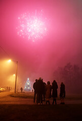 People celebrating new year with fireworks in the city.
