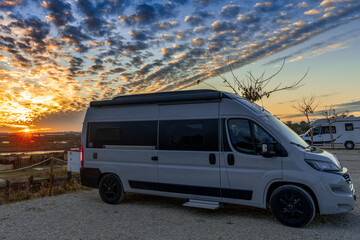 beautiful sunset on the coast of Andalusia with camper van and RV at campground during holidays