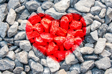 Red heart shape symbol on gravel road texture for valentines day background concept