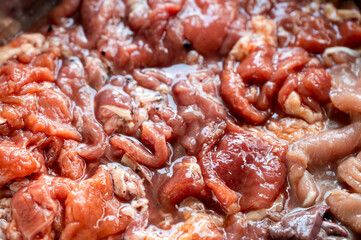 Various parts of raw sliced pork with marinated pork, pork belly, pork liver in stall