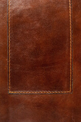 Dark brown leather texture with seam