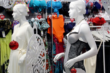 Female mannequins in underwear, winter sale. Lingerie store, bra, night dresses and swimsuits in a shop