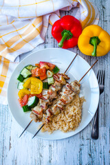 chicken souvlaki with salad and rice