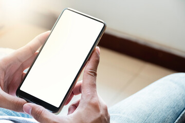 close up of boy's hands is using smart phone with blank screen.