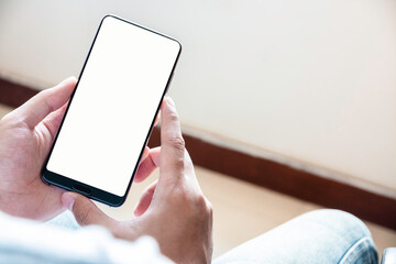 close up of boy's hands is using smart phone with blank screen.