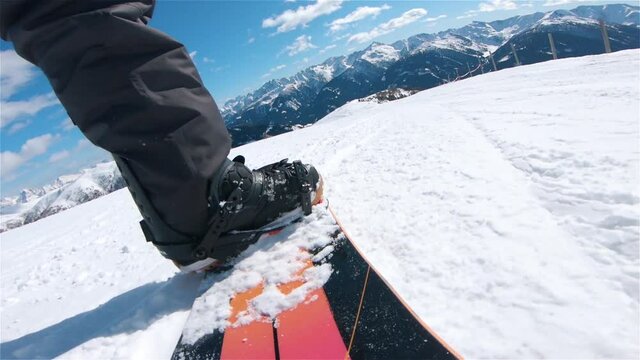 low angle view of snowboarder driving downhill