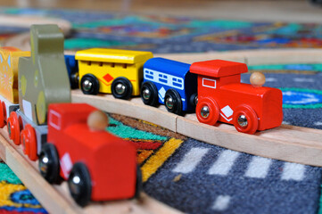 Colorful wooden trains on wooden train tracks, traditional toys