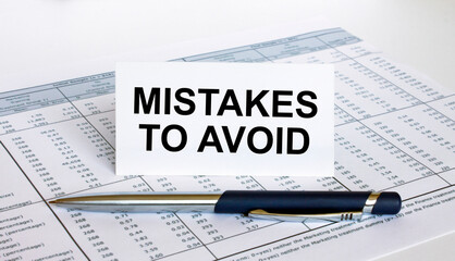 Text Mistakes To Avoid on white card with blue metal pen on financial table