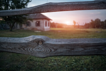 old wooden fence with ukrainian village on background