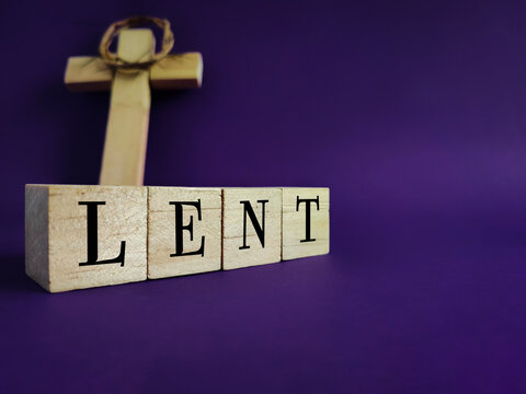 Lent Season,Holy Week and Good Friday concepts - word LENT on wooden blocks in purple vintage background. Stock photo.
