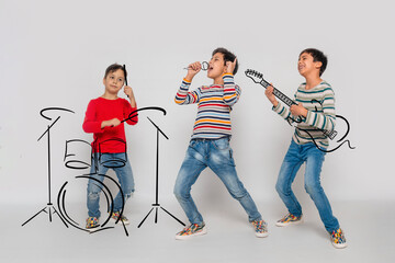 Three young boys dreaming of a musical career give a concert on imaginary instruments.