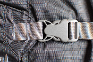 Gray plastic buckle on backpack