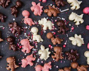 Milk chocolate candies lie on a black table