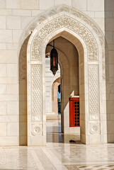 Arches and walls inlaid between the courtyards of the Sultan Qaboos Grand Mosque