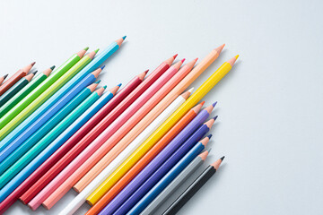 Colorful pencils in the case isolated on the gray background.