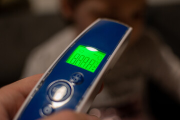 Hand holding the non-contact infrared thermometer