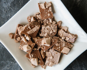 Handmade chocolate with pieces of freeze-dried fruit, banana and dry ice cream