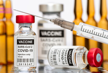 Impfung mit Ampulle und Impfstoff gegen Coronavirus COVID-19