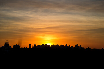 Photos of the sunset at the end of the day with the outline of the buildings in londrina, parana, brazil