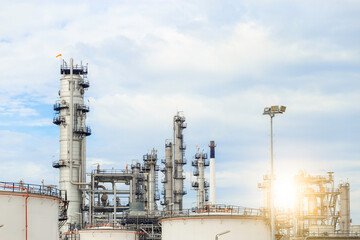 Industrial of oil refinery plant from industry zone ,Refinery factory oil storage tank and pipeline steel with blue sky.
