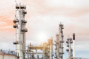 Industrial of oil refinery plant from industry zone ,Refinery factory oil storage tank and pipeline steel with sunset sky.