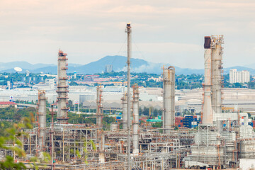 Fototapeta premium Industrial of oil refinery plant from industry zone ,Refinery factory oil storage tank and pipeline steel with sunset sky.