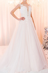 Fototapeta premium Bride at ceremony in wedding day. Woman in an expensive, luxury dress, details of models on the collection catwalk during the Bridal Week runway.