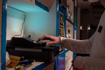 Close up bartender's hands  typing on cash register