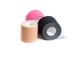 Kinesiological multi-colored tapes for fixing muscles during sports and after injuries on a white background.