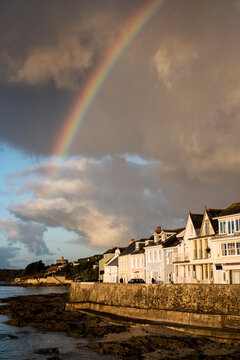 Cloudy sky with rainbow over Saint Mawes, Cornwall, UK.