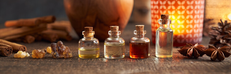Panoramic header of essential oil bottle with frankincense and Christmas spices - cinnamon and star anise
