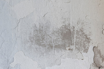Vintage grunge texture of old weathered dirty wall. Painted cracked walls, textured in cracks and drips of paint. Unique scenic unusual background. Cement wall with stain marks. A texture of an old