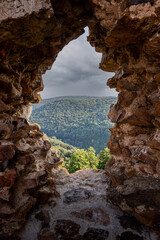 A scenic view through the crack in an old fortress wall